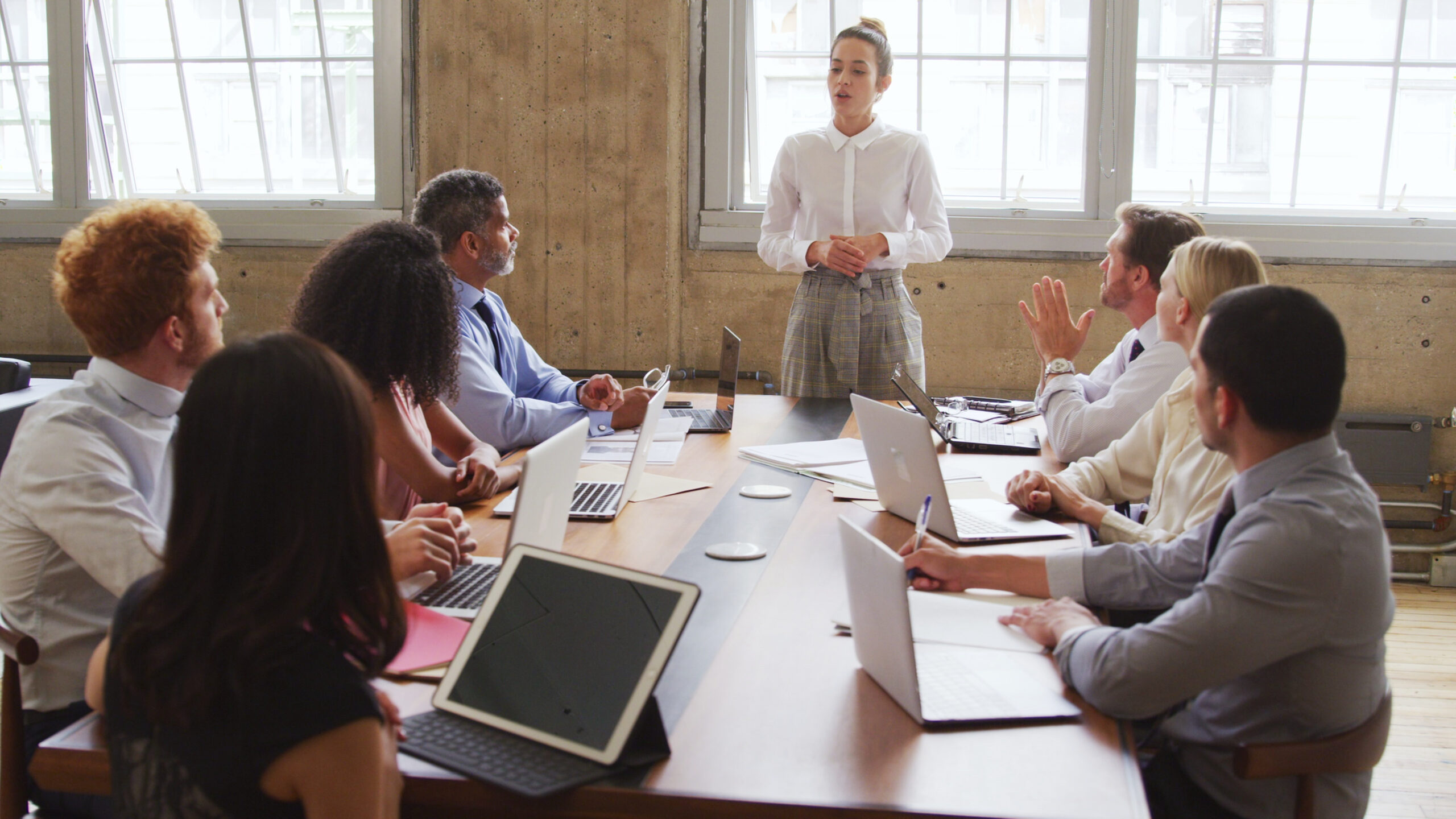 female-boss-leading-a-meeting-with-colleagues-in-a-boardroom-SBI-351637954